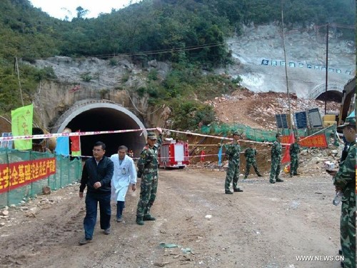 Photo taken with a mobile phone on Oct. 10, 2012 shows rescuers working at the accident site after an expressway tunnel collapsed at the section of Najia Township in Debao County, along the expressway between Baise City and Jingxi County in southwest China's Guangxi Zhuang Autonomous Region. Five people were dead and another injured in the accident, which occurred early Wednesday. Seven people were working within the tunnel under construction when the accident occurred. One escaped and six others were buried, according to local authority. (Xinhua/Ding Wen'gang) 