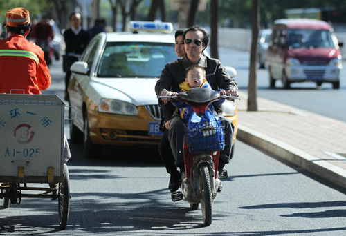 Motorized bikes and other vehicles often clog up Beijing's bicycle lanes but the capital is taking steps to improve conditions for cyclists. [Wang Jing/ China Daily]