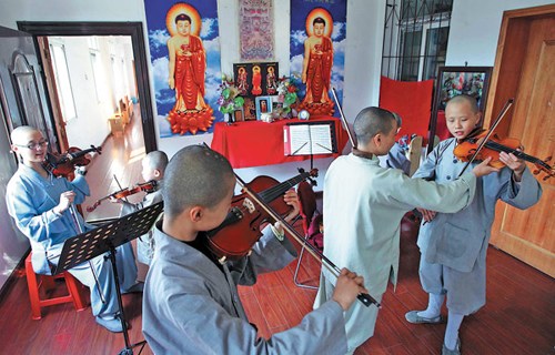 Monks and nuns from the Guangxuan Art Troupe practice stringed instruments seven hours a day, when they're not chanting sutras or doing hard labor. Photos by Wang Jing / China Daily