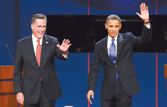 US Republican presidential candidate Mitt Romney and President Barack Obama wave to the audience during the first presidential debate at the University of Denver in Colorado on Oct 3. (Charlie Neibergall / Associated Press)