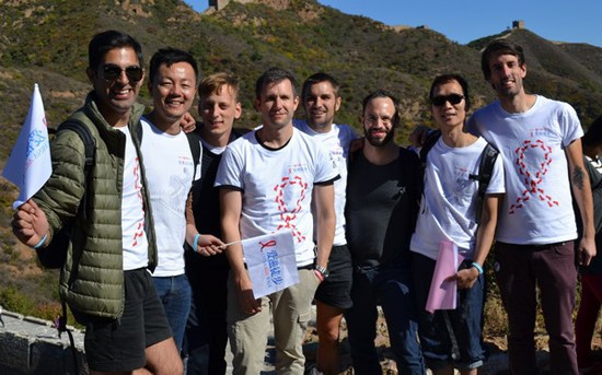 Hikers pose for a photo after arriving at the end of the Great Wall AIDS walk, an event to promote awareness about HIV/AIDS, in Beijing on Tuesday. [Xu Lin/China Daily]