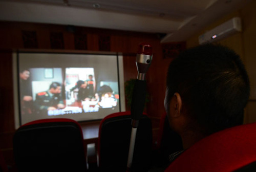 People with visual disabilities watch a film in the special cinema in Chengdu, Sichuan province, on Oct 16, 2012. [Photo/Asianewsphoto]