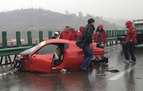 Medical workers try to save the driver of a Ferrari after an expressway accident in Shaanxi province on Monday. Mu Shan / for China Daily