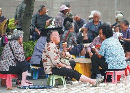 Elderly people enjoy their retirement on a street corner in Hong Kong. Provided to China Daily