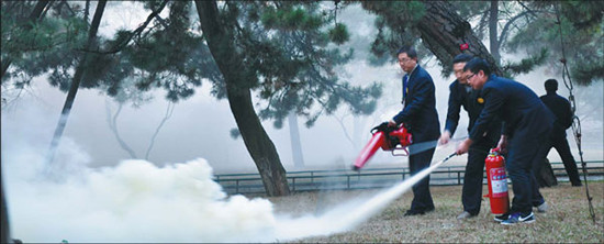 Security workers join in a fire control drill at one of the Outer Temples in Chengde, Hebei province. Liu Xiangrui / China Daily