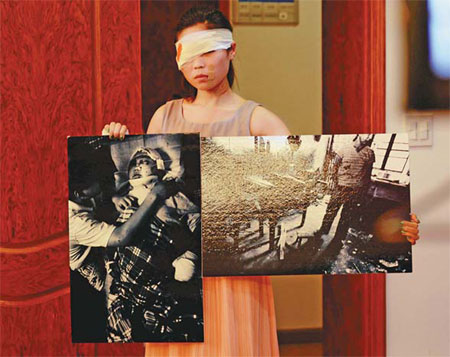 A volunteer depicting a victim of domestic violence shows pictures of abused victims during a lecture against domestic violence in Hangzhou, Zhejiang province, in September. Long Wei / for China Daily 