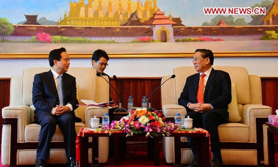 Choummaly Saygnasone (R), general secretary of the Central Committee of the Lao People's Revolutionary Party (LPRP) and Lao president, meets with Li Jianguo, a member of the Political Bureau of the Communist Party of China (CPC) Central Committee, and vice-chairman and secretary-general of the National People's Congress (NPC) Standing Committee, in Vientiane, capital of Laos, Dec. 1, 2012. (Xinhua/Liu Ailun)