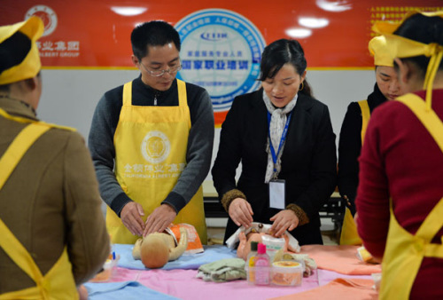 Li Dabin attends training to become a maternity matron in Changsha, Hunan province on Dec 1. Li, a former college teacher with a master's degree, gave up his former job and decided to become a maternity matron. He attends training in Changsha, Hunan province and has set up his own domestic service company in Kunming, Yunnan province. A maternity matron encompasses the role of nanny, nurse, cook and pre-school teacher and thus the salary can be more than 6,000 yuan ($963) in big cities such as Beijing and Shanghai. During peaks in birthrates, the demand for the service usually exceeds supply. [Photo/Xinhua]