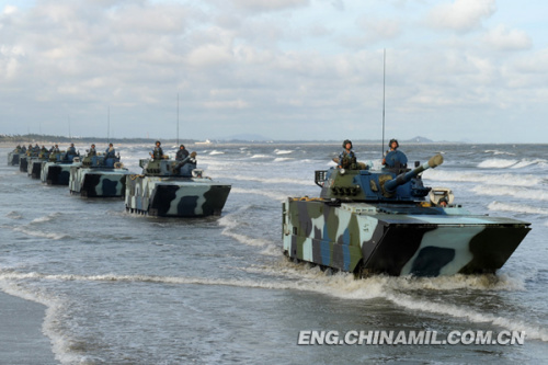 A brigade of the Marine Corps under the Navy of the Chinese Peoples Liberation Army (PLA), which was praised as land tiger, sea dragon and air eagle, carried out a series of amphibious armored training at the end of the year 2012 so as to solve the bottleneck problems in assessment. The photo shows the splendid moment of training. (China Military Online/Li Tang)