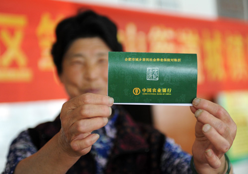 HOLDING TIGHT: A resident in Hefei, capital of Anhui Province, shows off her pension record book (DU YU)