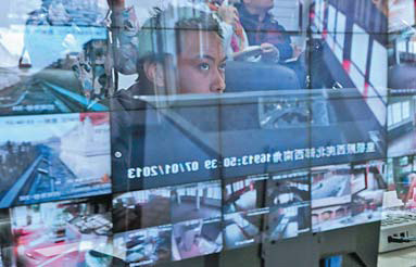 A staff member keeps an eye on exhibits in the Palace Museum through security cameras on Monday. The museum is updating its security system as it will open more areas. [Photo/China Daily]