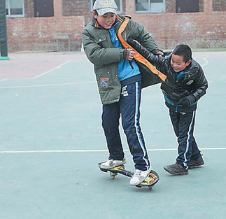 Two boys play during a break at the boarding school. 