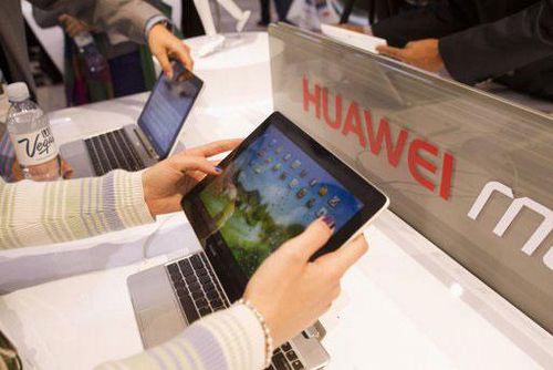 A woman looks over the Huawei MediaPad, a 10-inch Android-based notebook with detachable tablet, at the Huawei booth during the first day of the Consumer Electronics Show (CES) in Las Vegas January 8.