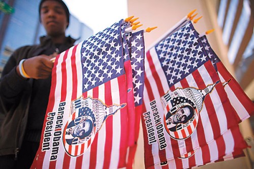 A vendor sells US flags with US President Barack Obama pictured on them, in Washington on Sunday. [Photo/Agencies] 