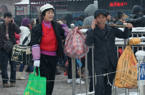 The much-anticipated journey home can entail a great deal of waiting at train stations and airports, as these images prove. Hopeful travelers at Beijing Railway Station on Sunday had weighty matters of baggage to consider while at Beijing Capital International Airport sleep was an option, at least for the very young. [PHOTOS BY WANG JING AND DU LIANYI / CHINA DAILY]