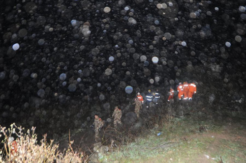 Rescuers work in rain at Yudong Village of Longchang Township in Kaili, southwest China's Guizhou Province, Feb. 18, 2013. Five people, including two children, were buried after a landslide hit the village around 11 a.m. Monday. Relief work was hampered as sporadic slides continued. (Xinhua/Tao Liang) 