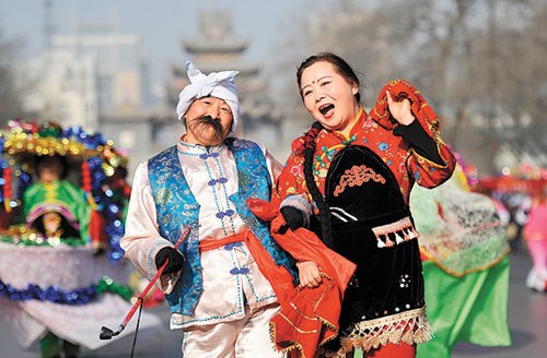 Residents in Yinchuan, Ningxia, get in on the act during a street parade on Sunday to celebrate the festival. PHOTO BY WANG PENG / XINHUA