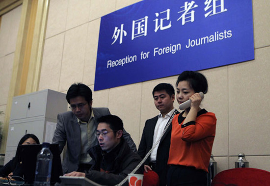 Staff members prepare to receive foreign journalists at the press center for the two sessions in the Media Center Hotel in Beijing. The upcoming annual sessions of the NPC, China's top legislature, and the CPPCC, the country's top political advisory body, opened their press center on Tuesday. Zhu Xingxin / China Daily 