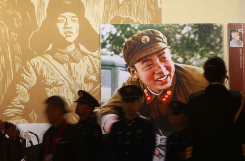 An exhibition, which opened on Monday at Beijing World Art Museum, showcases photos and audio material featuring Lei Feng. The young Chinese soldier, who died in 1962, is known for selflessly helping the needy. [Wang Jing / China Daily]