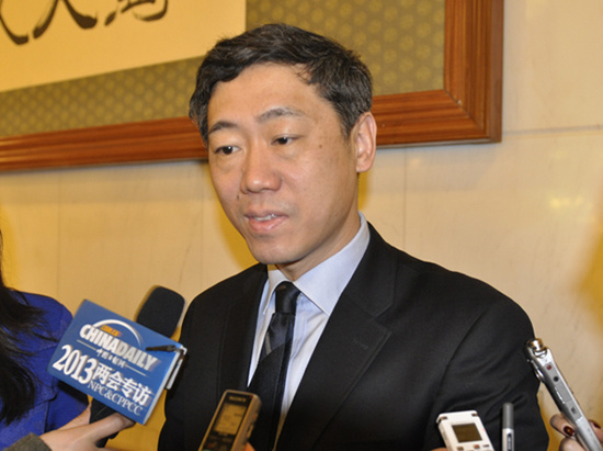 Li Daokui, professor at Tsinghua University and CPPCC National Committee member, takes interviews after the opening ceremony of the First Session of China's 12th National People's Congress on March 5, 2013.