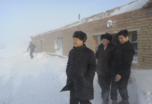 Chinese Premier Wen Jiabao (front) visits a village in Toli County of Tacheng, northwest China's Xinjiang Uygur Autonomous Region, on Jan. 24, 2010.  (Xinhua File Photo/Li Xueren)