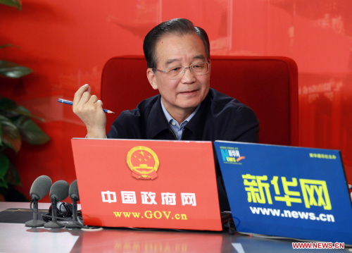 Chinese Premier Wen Jiabao gestures while holding an online chat with Internet users at two state news portals in Beijing, capital of China, Feb. 27, 2011. The two portals, namely www.gov.cn of the central government and www.xinhuanet.com of the Xinhua News Agency, jointly interviewed Premier Wen on Sunday with questions raised by netizens. (Xinhua File Photo/Pang Xinglei)