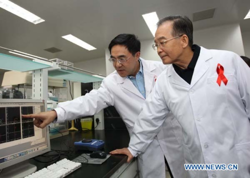 Chinese Premier Wen Jiabao (R) visits a HIV/AIDS research laboratory at the Chinese Center for Disease Control and Prevention (CCDCP) in Beijing, capital of China, Dec. 1, 2011. Premier Wen inspected the CCDCP on Thursday, which marks the 24th World AIDS Day, for its work on the HIV/AIDS control and prevention and had a discussion with HIV positive people, volunteers, medical experts and representatives of relevant international organizations. (Xinhua File Photo/Liu Weibing)