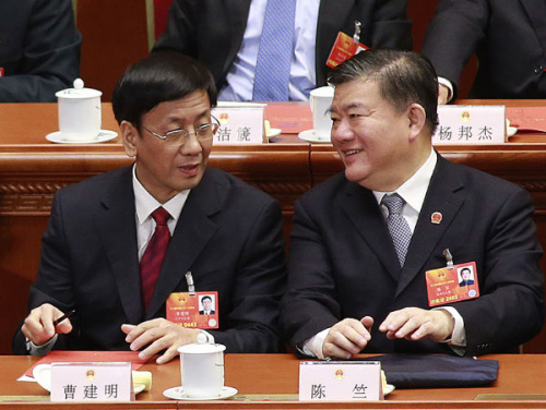 Cao Jianming (left) talks to Chen Zhu, vice-chairman of the 12th National Peoples Congress Standing Committee, at a plenary meeting of the annual NPC session in Beijing on Friday. Cao was re-elected procurator=general of the Supreme Peoples Procurator