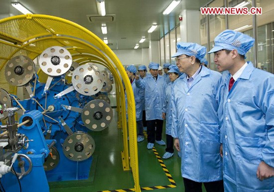 In this file photo taken on Feb. 22, 2013, Zhang Dejiang (2nd R) visits a laboratory on the application of the superconducting technology at a plant of Futong Group in Tianjin, north China. (Xinhua/Huang Jingwen)