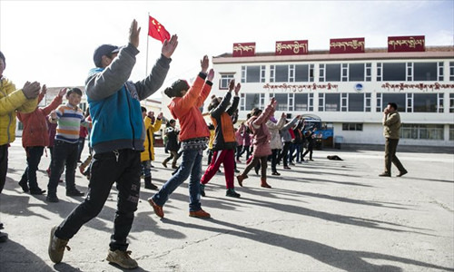 Students do morning exercises at a primary school in Aba on March 4. 