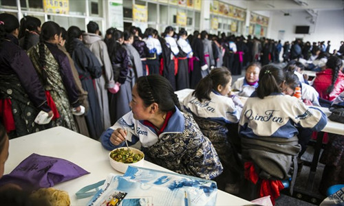 Students have lunch in a cafeteria at Hezuo No.3 High School in Gannan, Gansu Province on March 7. 