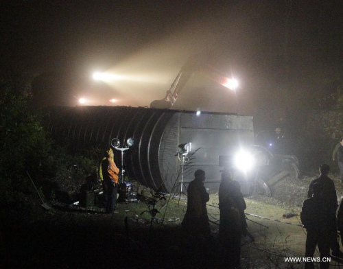 Rescuers work at the scene of a train derailment accident in the Hongshandian-Banqiao section of the Loudi-Shaoyang Railway in Loudi, central China's Hunan Province, in the early hours of March 27, 2013. A freight train running on the rail line was derailed by a rainstorm-triggered landslide at around 9:18 p.m. (1318 GMT) on Tuesday. There has been no casualty reports while road maintainence workers are still working to recover traffic on the affected rail line. (Xinhua/Guo Guoquan) 