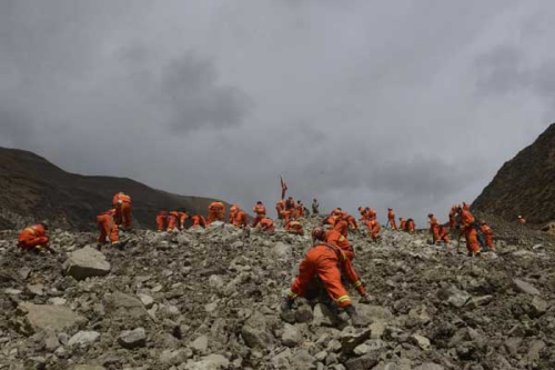 Rescue workers conduct search and rescue work at the site where a large-scale landslide hit a mining area in Maizhokunggar County of Lhasa, southwest China's Tibet Autonomous Region, March 30, 2013. (Xinhua/Purbu Zhaxi) 