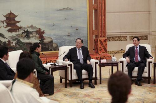 Yu Zhengsheng (2nd R), a member of the Standing Committee of the Political Bureau of the Communist Party of China Central Committee and chairman of the National Committee of the Chinese People's Political Consultative Conference (CPPCC), meets with members of the work team organized to promote Gyumey Dorje's spirit among Party members in Beijing, capital of China, April 10, 2013. After 11 years of dedication and hard work as a grassroots official, Gyumey Dorje died of a stroke in May 2012 while serving as Khampa Tibetan chief of Wari Township in Sichuan's Garze Tibetan Autonomous Prefecture. (Xinhua/Ding Lin) 