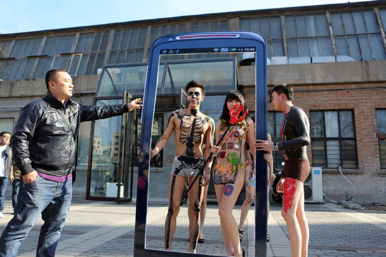 Protesters at Beijing's 798 art district call for the protection of cellphone users' privacy on Sunday. Several used body painting to protest against telecom operators  and cellphone software  that may leak or sell users' personal information. CANG GO