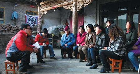 Staff from Beijing Zhongze Women's Legal Counseling and Service Center talk with rural women in Qinghai in 2009. Provided to China Daily