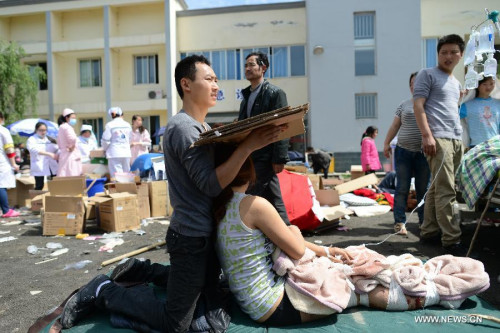 An injured woman receives medical treatment at the People's Hospital in Lushan County, southwest China's Sichuan Province, April 20, 2013. A 7.0-magnitude earthquake hit Sichuan Province's Lushan County of Ya'an City Saturday morning.  (Xinhua/Jiang Hongjing)