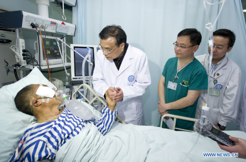 Chinese Premier Li Keqiang (2nd L) visits a patient seriously injured in an earthquake, at Huaxi Hospital in Chengdu, capital of southwest China's Sichuan Province, April 21, 2013. A 7.0-magnitude earthquake jolted Lushan County of Sichuan Province on April 20 morning. (Xinhua/Huang Jingwen)