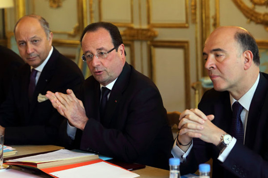 French Foreign Affairs Minister Laurent Fabius (left), President Francois Hollande (center) and Finance Minister Pierre Moscovici attend a government strategic investments meeting at the Elysee Palace in Paris, on Wednesday. Philippe Wojazer / Reuters