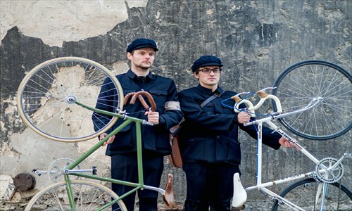 Expats dressed in zhongshan suits pose with their fixed-gear bicycles