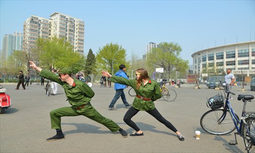 a foreign duo dressed as red guards mimic last year's viral Liaoning-style meme