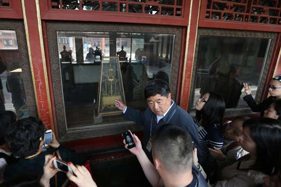 Beijing's Palace Museum Curator Shan Jixiang talks to journalists at the museum's Palace of Blessings to Mother Earth (Yi Kun Gong) on Sunday after an antique clock was damaged by a tourist on Saturday. Lin Hui / For China Daily 