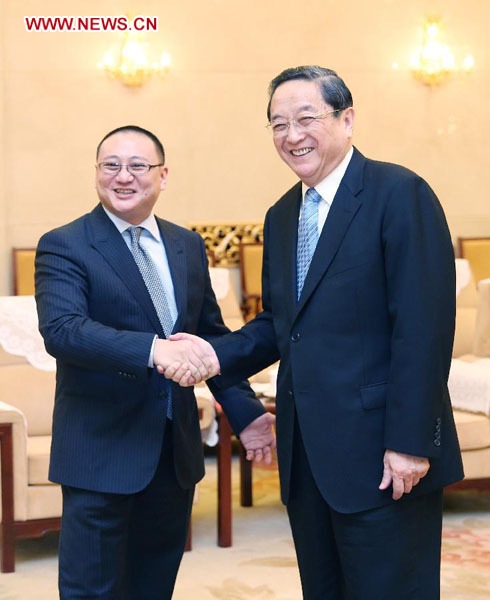 Yu Zhengsheng (R), chairman of the National Committee of the Chinese People's Political Consultative Conference, meets with Duncan Wang, chief executive officer of the Taiwan-based United Daily News (UDN) Group and head of a visiting UDN delegation, in Beijing, capital of China, May 22, 2013. (Xinhua/Yao Dawei)