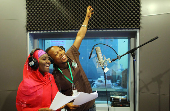 Nastru Sani (right) and Abdullahi Kassim, both from Nigeria, dub a Chinese TV drama in Beijing. Zou Hong / China Daily