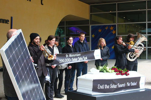 The European Alliance for Affordable Solar Energy holds a symbolic funeral march in front of the European Commission's headquarters in Brussels. The march highlights the more than 200,000 jobs expected to be lost as a result of the commission's plans to impose punitive duties on imports of solar products from China. Tuo Yannan/China Daily