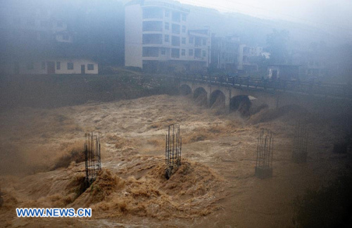 A building site is flooded in Gaoluo Township, Xuan'en County, Enshi Tujia and Miao Autonomous Prefecture of central China's Hubei Province, June 6, 2013. Torrential rainfall made parts of Enshi flooded on Thursday morning, and a total of 513 residents have been evacuated. (Xinhua)