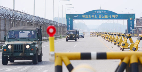 Military vehicles travel on a bridge leading to the Kaesong Industrial Complex in the Democratic People's Republic of Korea on Friday. The DPRK proposed to hold a working-level meeting in Kaesong, while the Republic of Korea has requested to hold it in Panmunjom. Jeon Sin / REUTERS