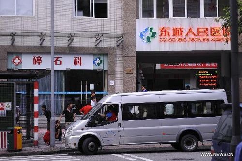 Employees of the Hsu Chi Food Co. Ltd are sent to a hospital in Dongguan, south China's Guangdong Province, June 11, 2013. A total of 160 staff from the food company were suspected of suffering from food poisoning, a company source said on Wednesday. (Xinhua/Wu Lu)