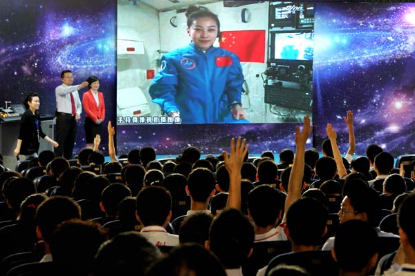 Astronaut Wang Yaping teaches a class from space to the High School Affiliated to Renmin University of China in Beijing on Thursday. Gao Haitao / For China Daily 