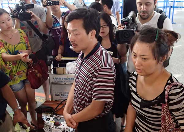 The parents of Wang Linjia, who died in the San Francisco plane crash on Saturday, answer questions at a Shanghai airport on Monday.GAO ERQIANG / CHINA DAILY 